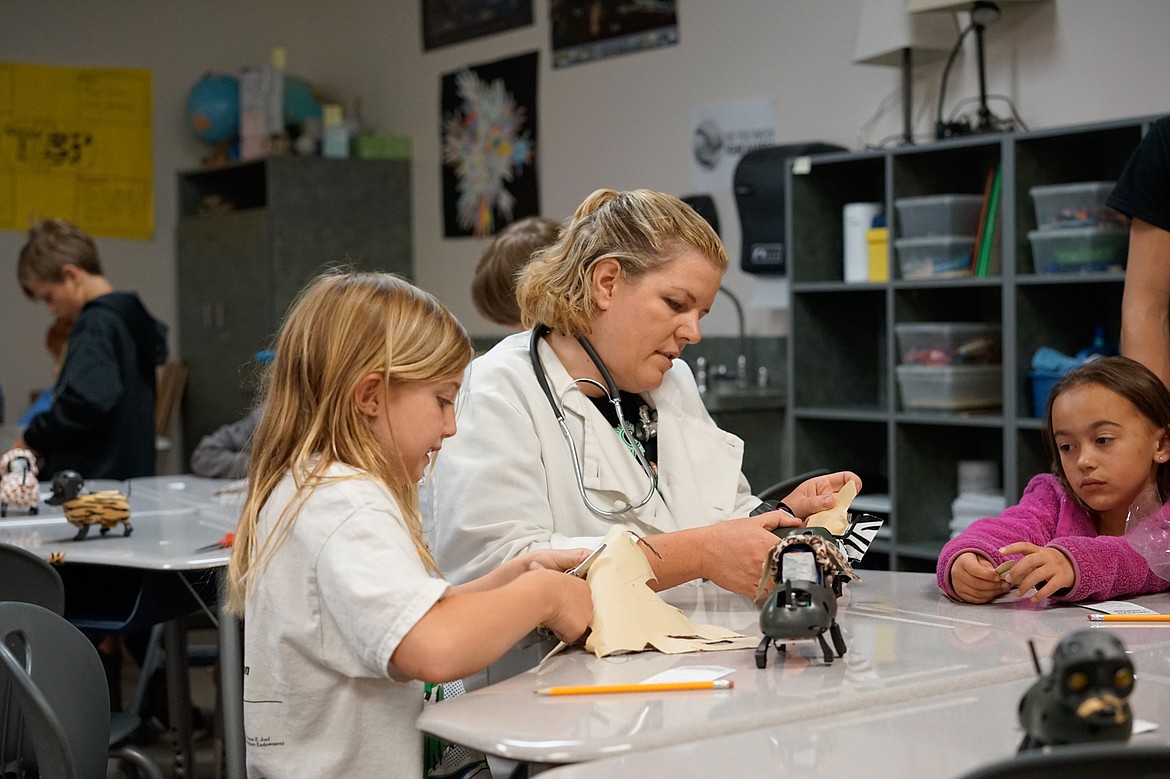 Teacher Holly Piazza works with Timber Massey at Camp Invention at Whitefish Middle School last week.