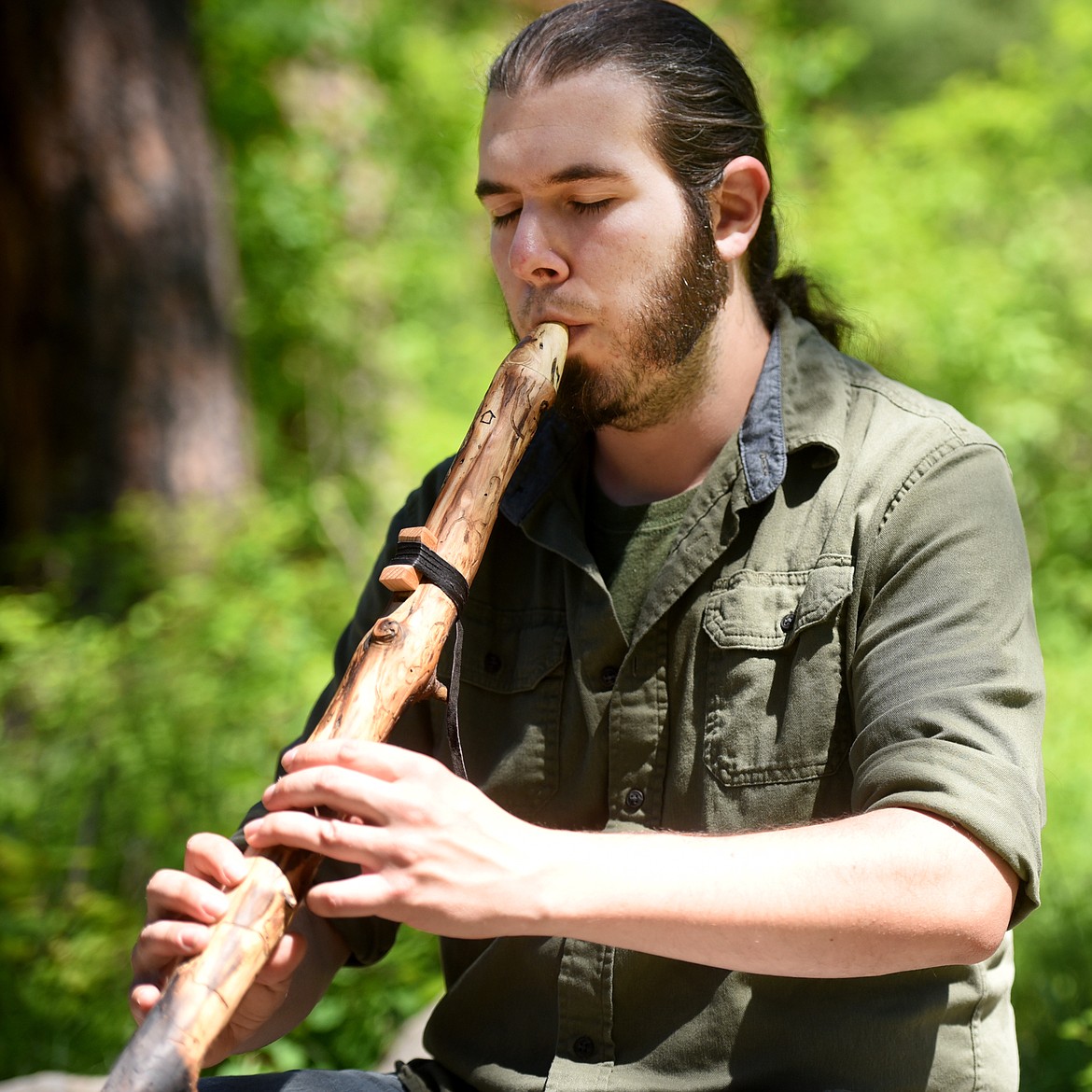 Niko Keys plays one of the flutes he made.