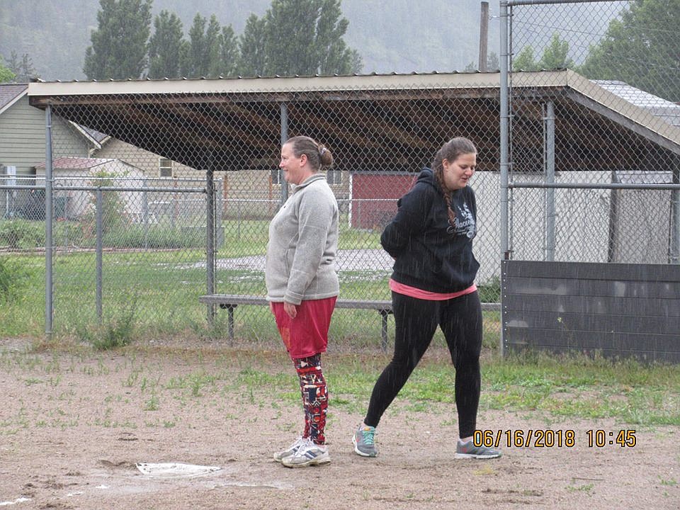 PEAK Foundation and Alberton Railroad Days Foundation members Jaime Odell and Zelma Kromery enjoy a game of kickball last Saturday in Alberton despite rain and chilly temperatures. (Photo courtesy of Sheri Bayer)