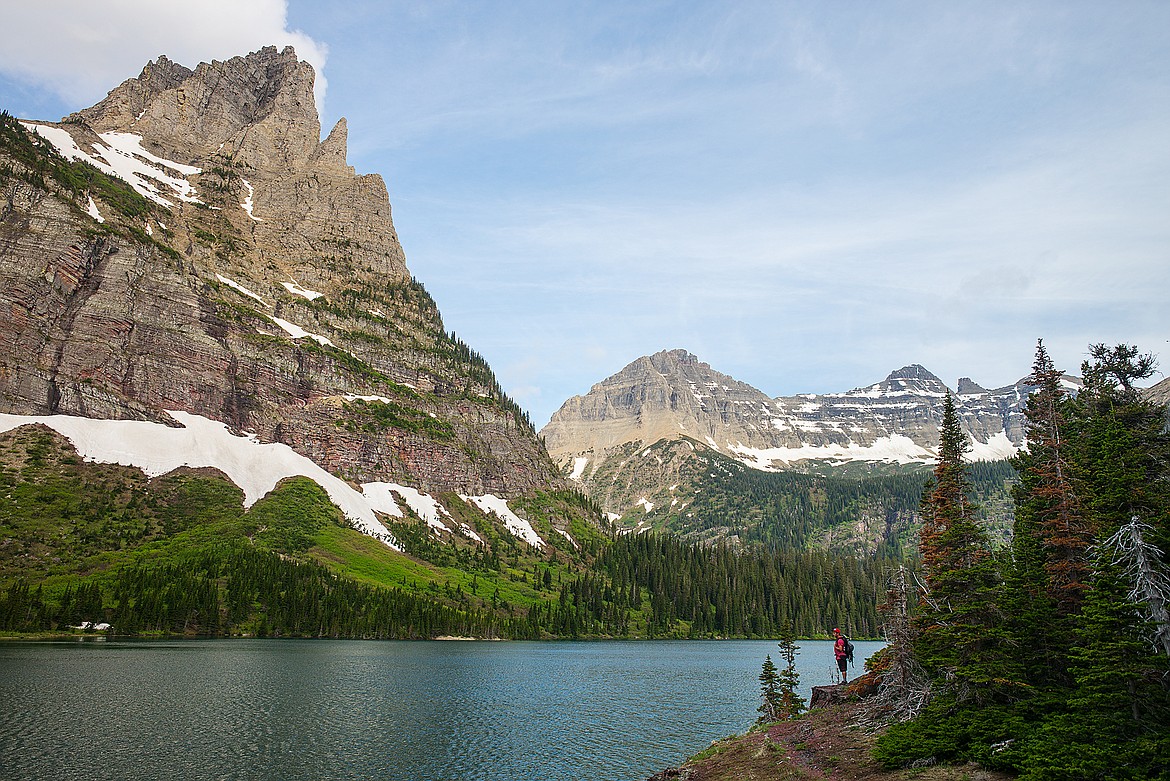 A hiker looks over Mokowanis Lake in Glacier National Park.