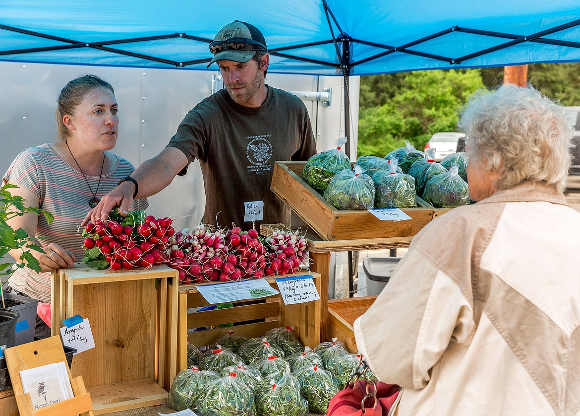 Bonnie and Rudy Geber sell produce at Libby Farmers Market on May 24. (John Blodgett/The Western News)