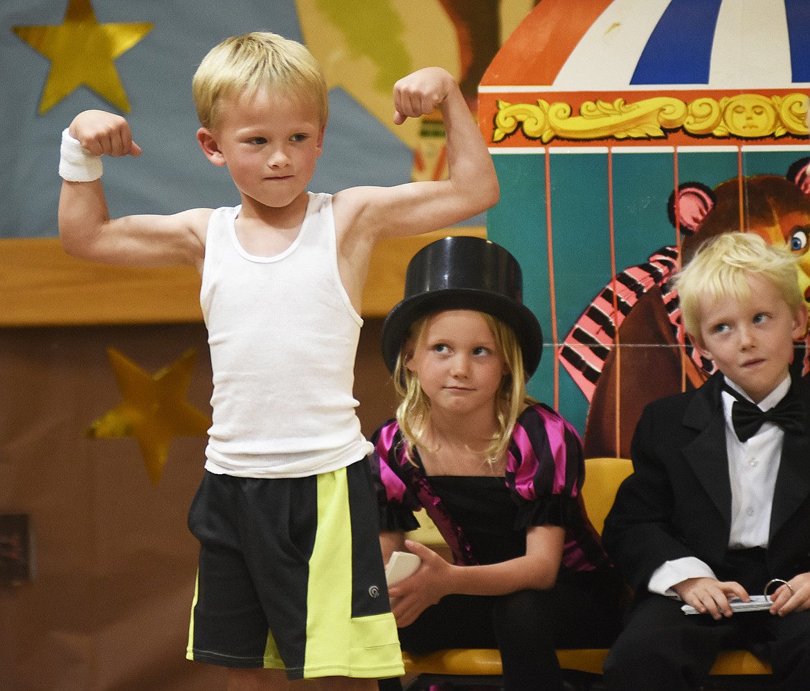 Muldown Elementary kindergartener Beck Archie flexes his muscles while Makena Hanchett and Myles Schott look on last week during the annual Muldown Kindergarten Circus. (Daniel McKay photos/Whitefish Pilot)