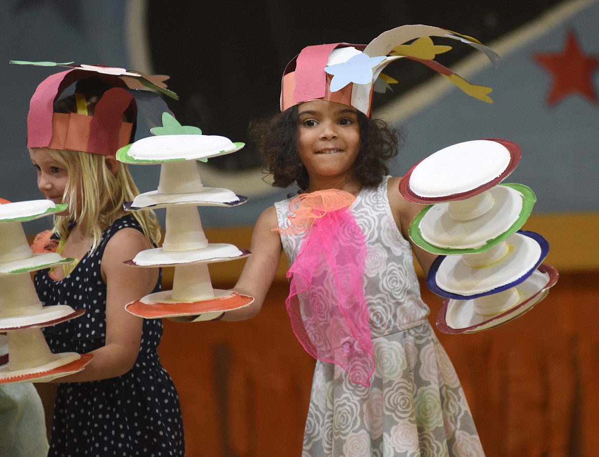 Coral Ryerson balances some plates and cups as a juggler last week during the circus at Muldown school.