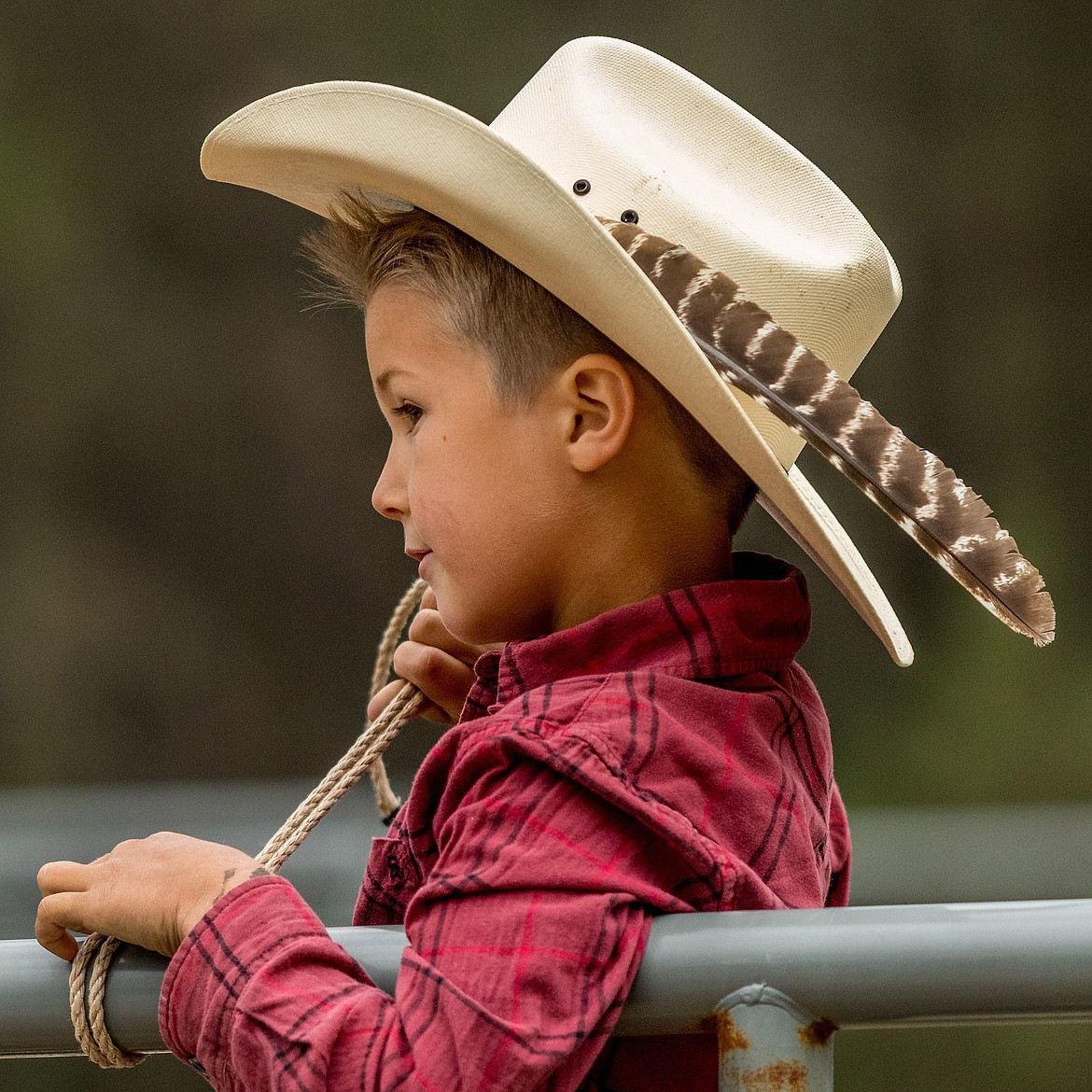 Lane Eash, 6, of Trego watches the action at Saturday night&#146;s Incredi-Bull event at J. Neils Park in Libby. His father, Gerald Eash, was one of the bull riders who competed. (John Blodgett/The Western News)