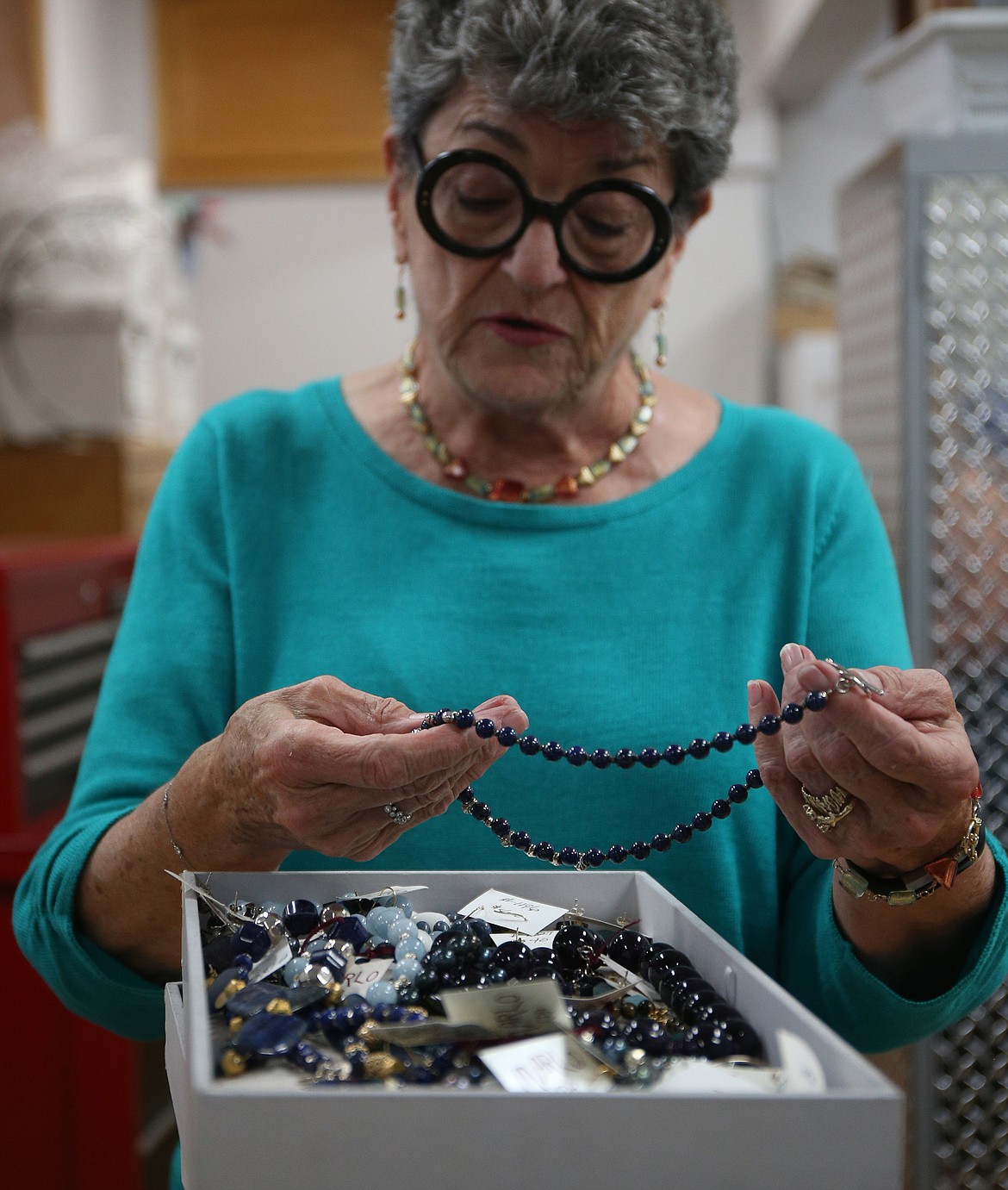 Marlo Faulkner, of Coeur d'Alene, sorts through bracelets, necklaces and earrings for her last trunk show Sunday from noon to 4 p.m. in Cheryl Burchell Goldsmiths. (LOREN BENOIT/Press)