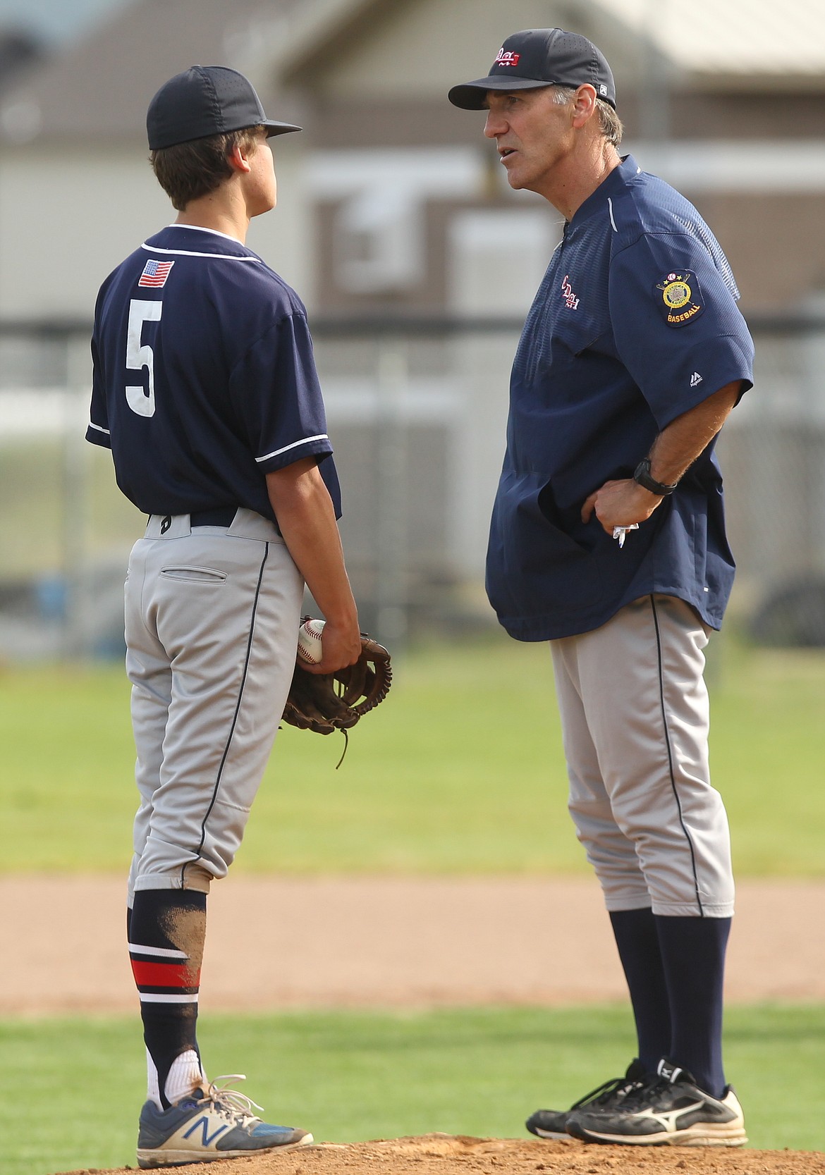 Coeur d&#146;Alene head coach Kevin Dunton chats with pitcher Zach Mackimmie during a mound visit Friday vs. Prairie.