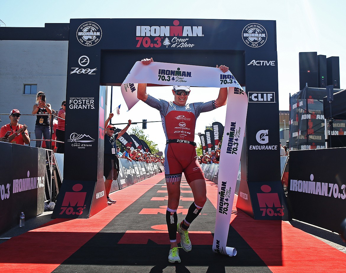 Matt Hanson of Storm Lake, Iowa, crosses the Ironman 70.3 finish line first with a time of 3 hours, 50 minutes and 9 seconds.