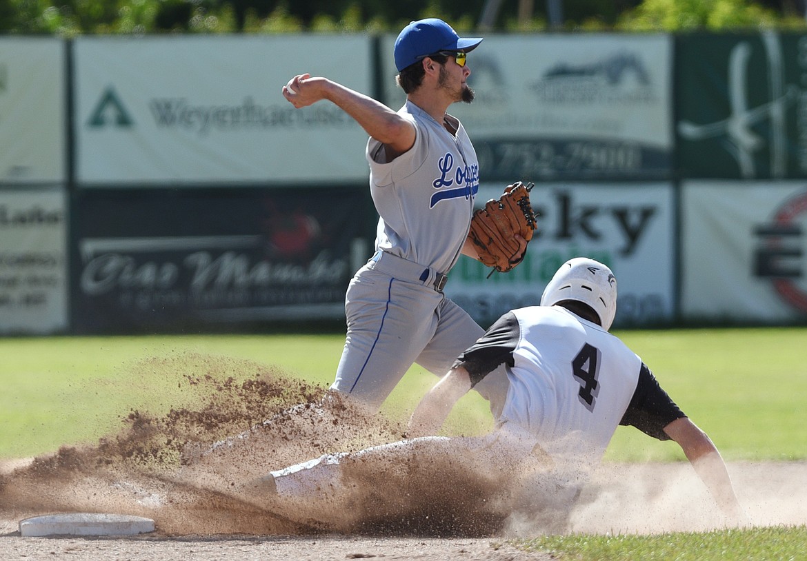 Glacier Twins A's Matthew Morrison is forced out at second by Libby Loggers A shortstop Tim Carvey on a double play attempt in the first inning at Memorial Field. (Casey Kreider/Daily Inter Lake)