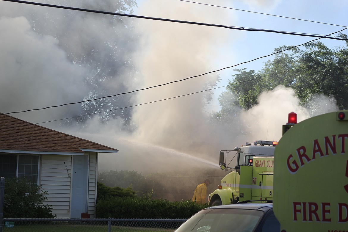 Richard Byrd/Columbia Basin Herald
Firefighters battle Wednesday morning's blaze on Airway Drive Northeast in Moses Lake.