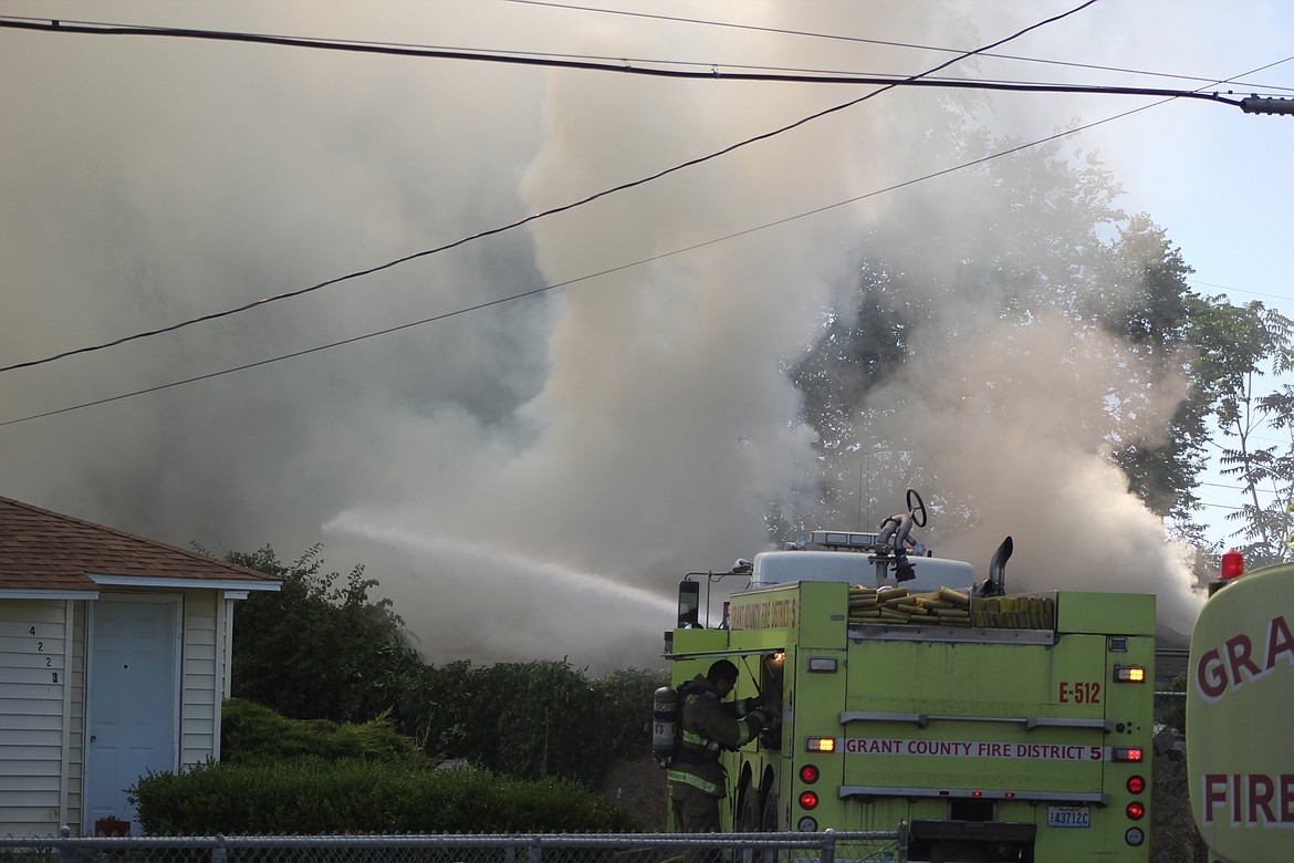 Richard Byrd/Columbia Basin Herald
Firefighters battle Wednesday morning's blaze on Airway Drive Northeast in Moses Lake.