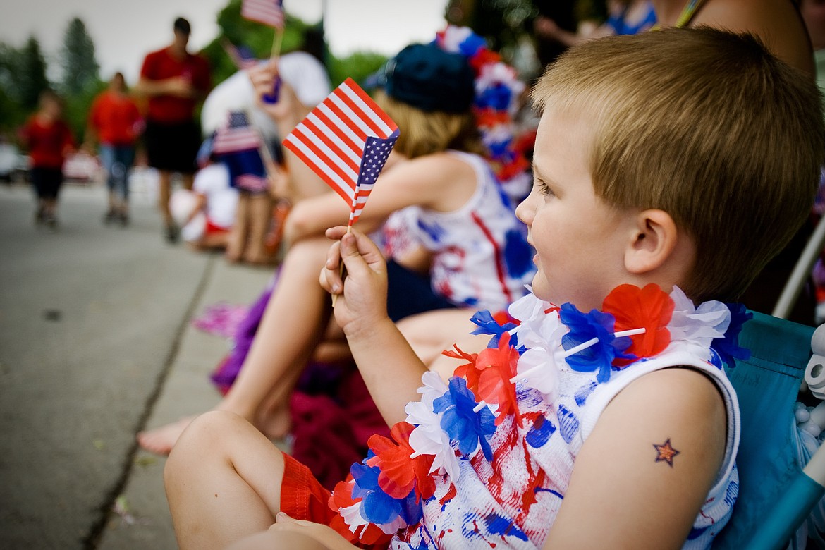 SHAWN GUST/Press  

Kolton Mertens happily waves an American Flag Friday while watching the Fourth of July parade in Coeur d'Alene.
