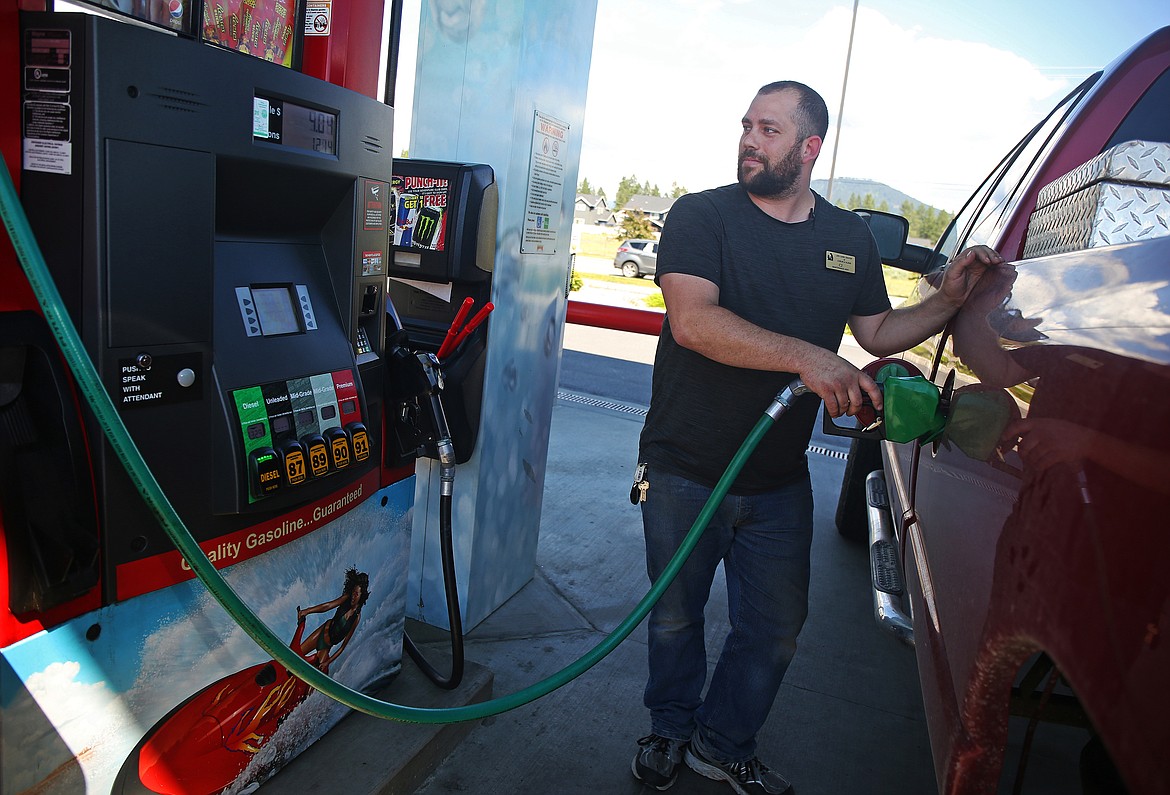 Coeur d'Alene resident C.J. Jensen fills up his Dodge pickup at Maverick on Wednesday in Coeur d'Alene.  The gas price average was $3.12 per gallon in Coeur d'Alene on Wednesday, according to AAA. (LOREN BENOIT/Press)