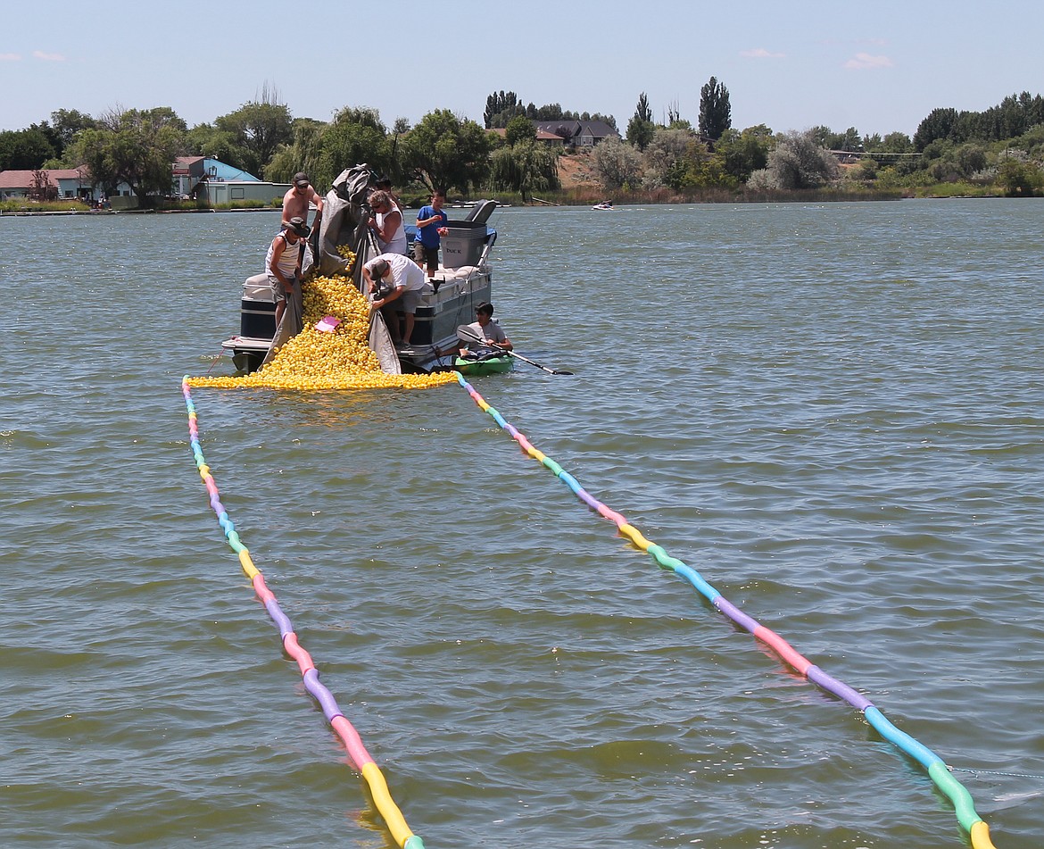 Joel Martin/Columbia Basin Herald
A cascade of rubber duckies flows into Moses Lake to kick off the Duck Derby Saturday. The event is a fundraiser for the Boys and Girls Club.