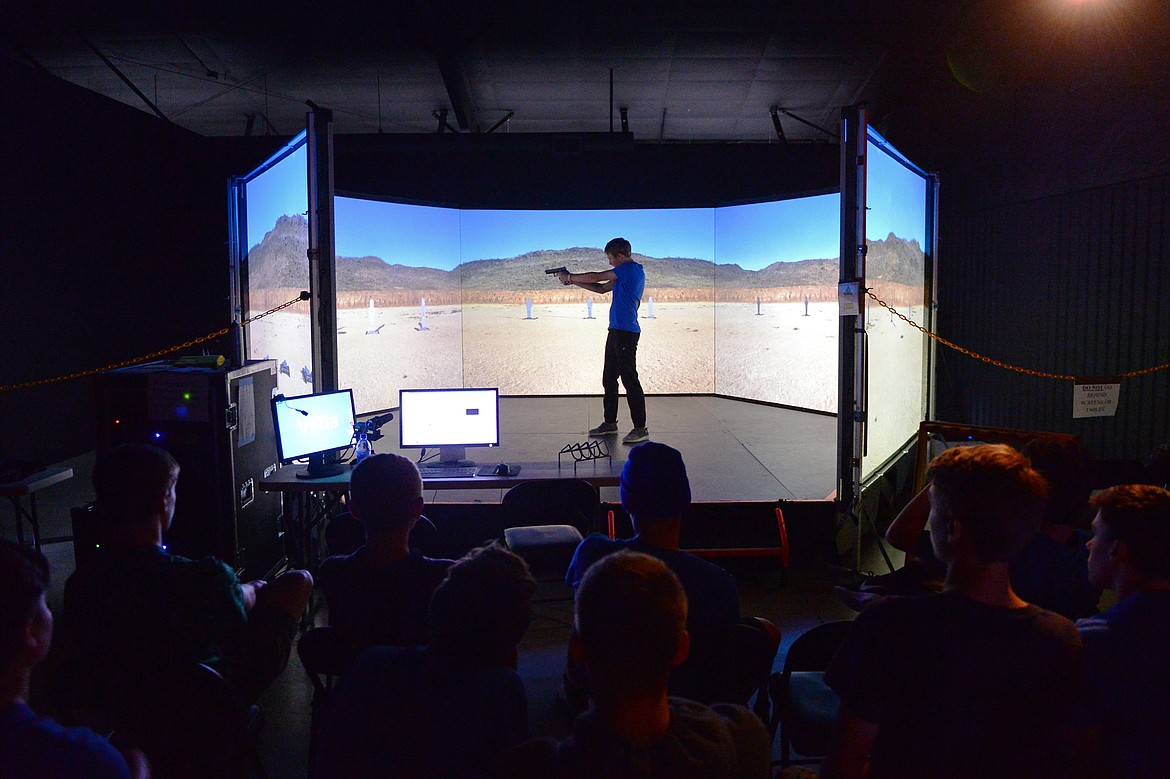 Tommy Wells particpates in a target shooting simulation during Kalispell Police Department's Junior Academy at Northwest Shooter on Friday. (Casey Kreider/Daily Inter Lake)