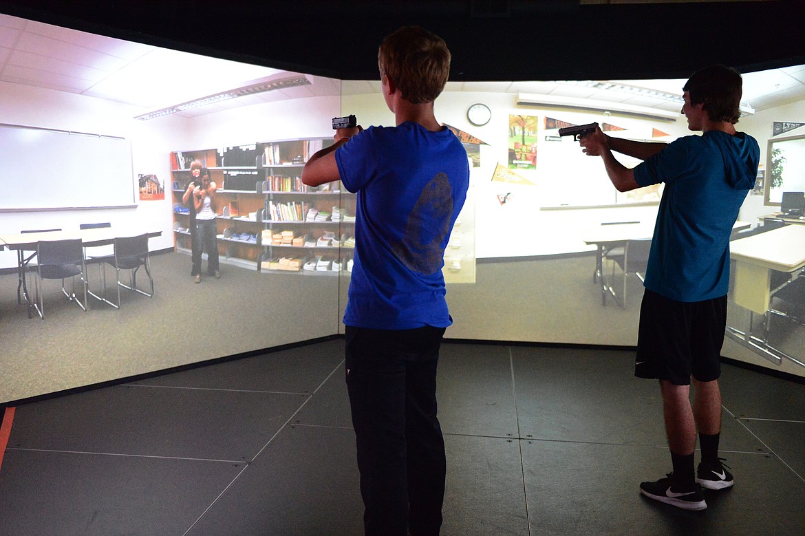Tommy Wells, left, and Eric Bott participate in a school shooting simulation during the Kalispell Police Department's Junior Academy at Northwest Shooter on Friday. (Casey Kreider/Daily Inter Lake)