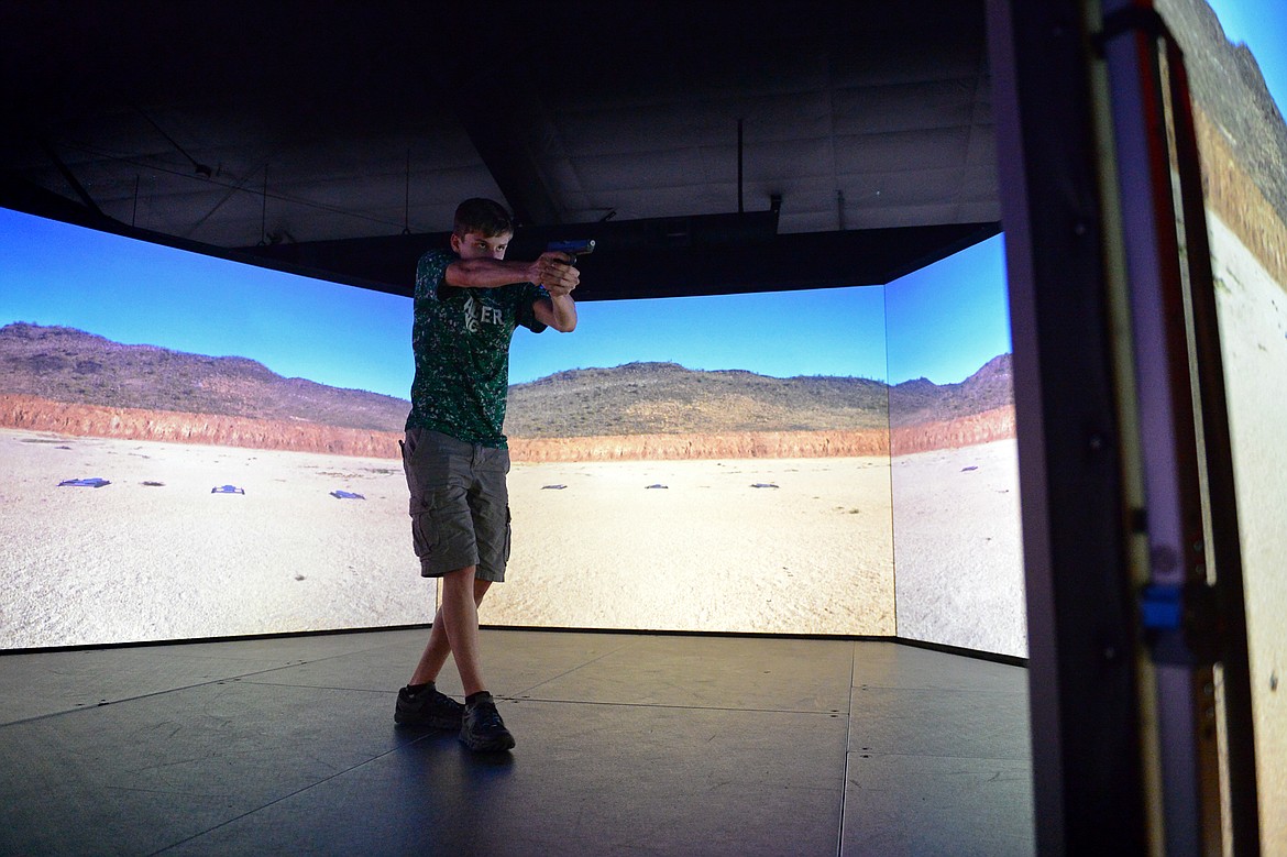Jacob Inabnit participates in a target shooting simulation during Kalispell Police Department's Junior Academy at Northwest Shooter on Friday. (Casey Kreider/Daily Inter Lake)