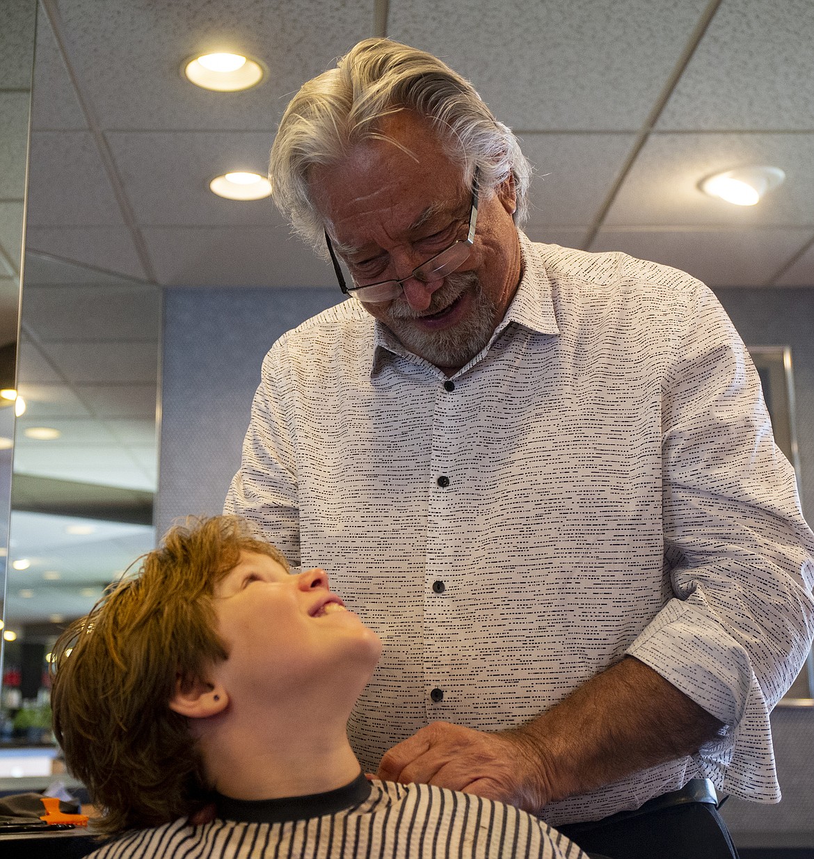 Alyssa Robinson, 10, and salon owner Steve LaTourrette share a kind-hearted moment at the end of a hair appointment. (LOREN BENOIT/Press)