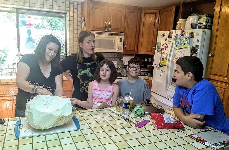 Photo by JOE WARD
Shane Cleve, Elissa Cleve, Isaac Cleve and Evan Cleve watch as the giant mushroom is carved up.