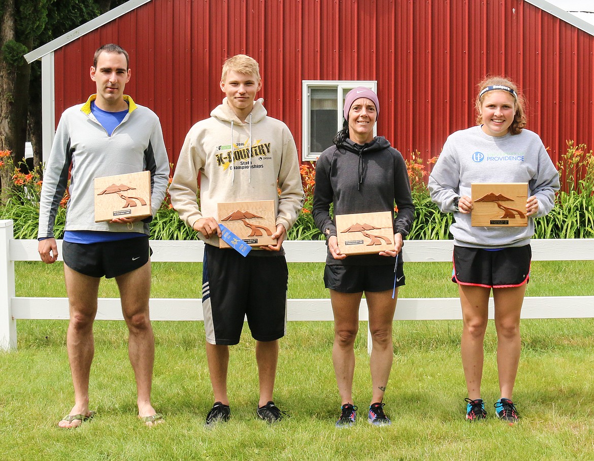 Photo by MANDI BATEMAN
Men&#146;s 10K winner Micah Krmpotich, Men&#146;s 5K winner Caleb Gleason, Women&#146;s 10K winner Darce Claus, and Women&#146;s 5K winner Jordan Young with their handcrafted wood trophies made by Bill Dettelbach.