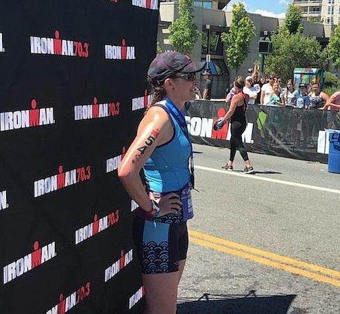 Courtesy photo// Sheena Braulick takes in her accomplishment after crossing the finish line at the Ironman 70.3 last weekend.