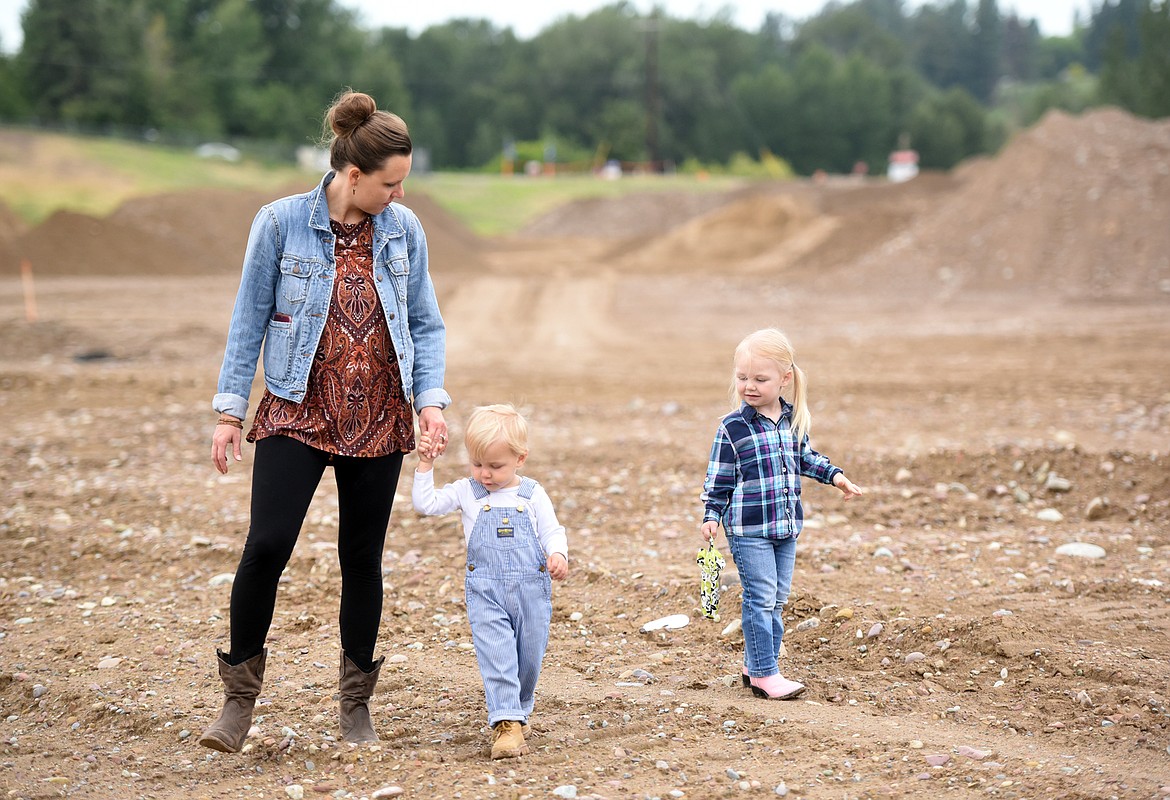 Ashley Fischer, the daughter of CHS Mountain West General Manager Mark Lalum, strolls with her children, Kate, 3, and Luke, 2, at the groundbreaking event on Thursday morning, June 21, in Kalispell.(Brenda Ahearn/Daily Inter Lake)