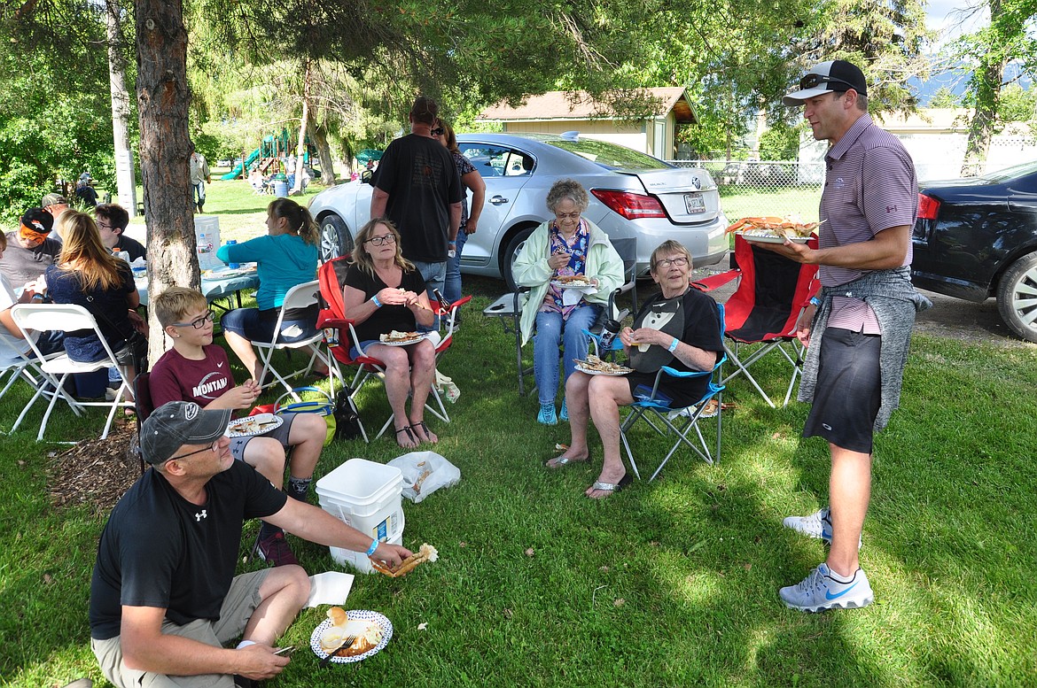 FINDING SHADE so they could enjoy their crab legs are, left to right, Bill Ross, Coda Ross, Connie Ross, Dorothy Webster, Penny Ross and Jamie Buhr, standing. (Ashley Fox/Lake County Leader)