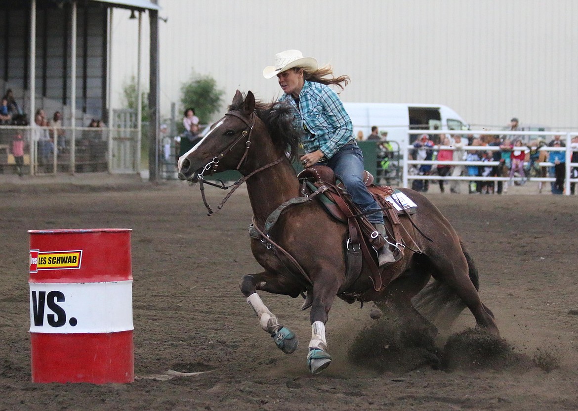 Photo by MANDI BATEMAN
This gal and her partner raced around the barrel in a keen effort to win.