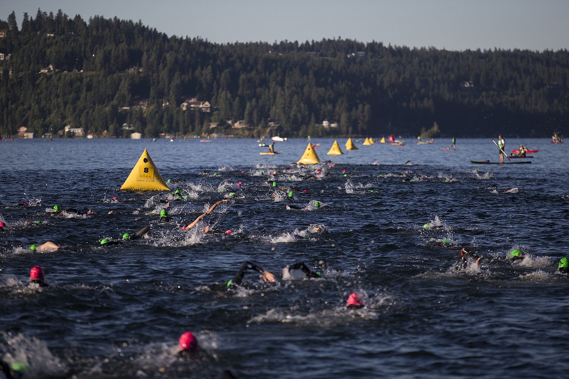 LOREN BENOIT/Presswomen Ironman competitors swim in Lake Coeur d'Alene.