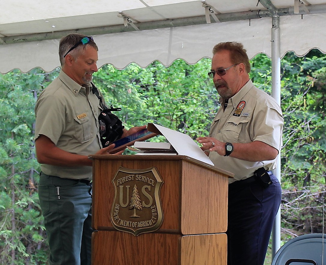 IDAHO PANHANDLE National Forest Supervisor Dave Reichter received an award from Phil Edholm, president of the Lookout Associates, LLC, for his dedication to the Route of the Hiawatha trail rail bike system during a 20-year celebration held on June 23 at the route&#146;s east portal.