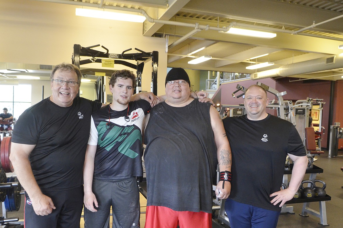 Special Olympics athletes Chandler Krahn and Sylvester Vermillion, center flanked by their coaches Mark Kuhr, left, and Rock Henderson, right, take a break during a training session at The Wave recently. Krahn, of Charlo, is a member of the Charlo Vikings and Vermillion, of Columbia Falls, is on the Whitefish Thunder team. Both athletes are headed to the Special Olympic United States Games in Seattle to compete in powerlifting.  (Heidi Desch/Whitefish Pilot)