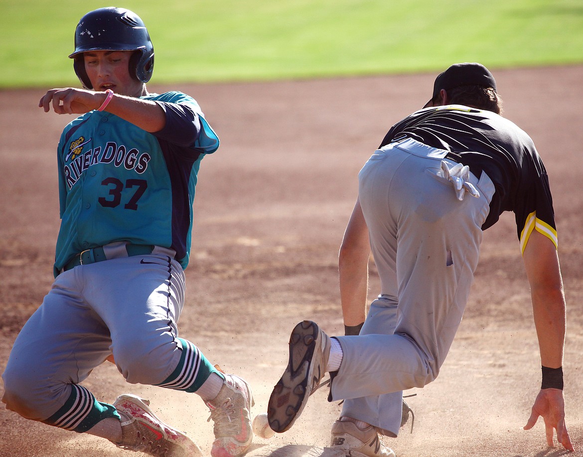 Rodney Harwood/Columbia Basin Herald
Columbia Basin River Dogs runner Evan Devolve (37) slides safely into third base as Spokane's Dylan Grogran tries to come up with the throw during Senior Babe Ruth League action at Johnson-O'Brien Stadium on Tuesday.