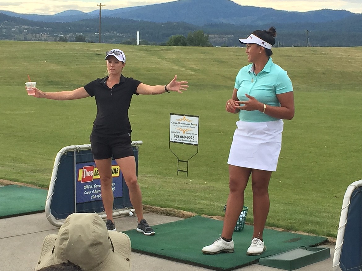 MARK NELKE/Press
Professional golfer Brittany Bomar, left, and two-time women&#146;s world long drive champion Phillis Meti talk to a crowd of roughly 100 at a long drive exhibition Meti put on Tuesday evening at Prairie Falls Golf Club in Post Falls.