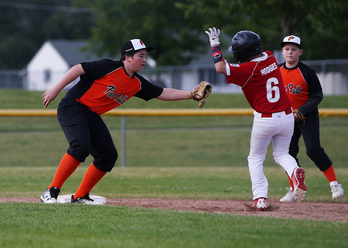 Brent Ludiker, of Post Falls, tags out Sandpoint baserunner Tyson Hodges in Friday&#146;s Little League District 1 tournament Majors game at Canfield Sports Complex. (LOREN BENOIT/Press)