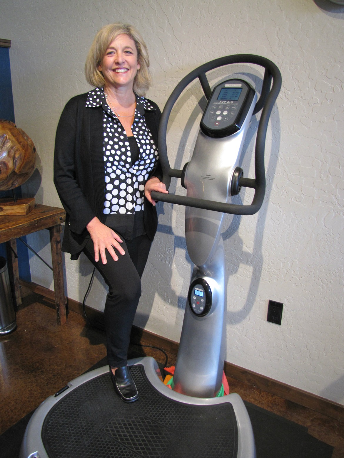 Sheree DiBiase, owner of Lake City Physical Therapy, demonstrates vibration plate therapy at her Hayden office. (KEITH ERICKSON/Coeur Voice)
