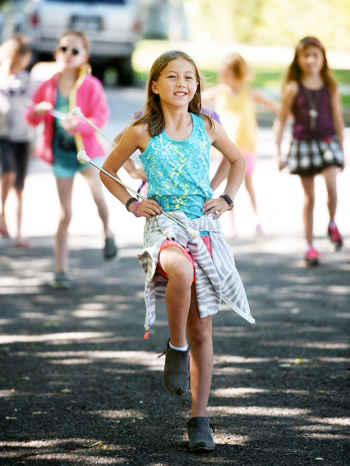 Jubilee Rutz and members of the Treasure State Twirlers practice outside Hedges Elementary on Tuesday morning, June 26. The Twirlers will be taking part in the Fourth of July Parade. (Brenda Ahearn/Daily Inter Lake)