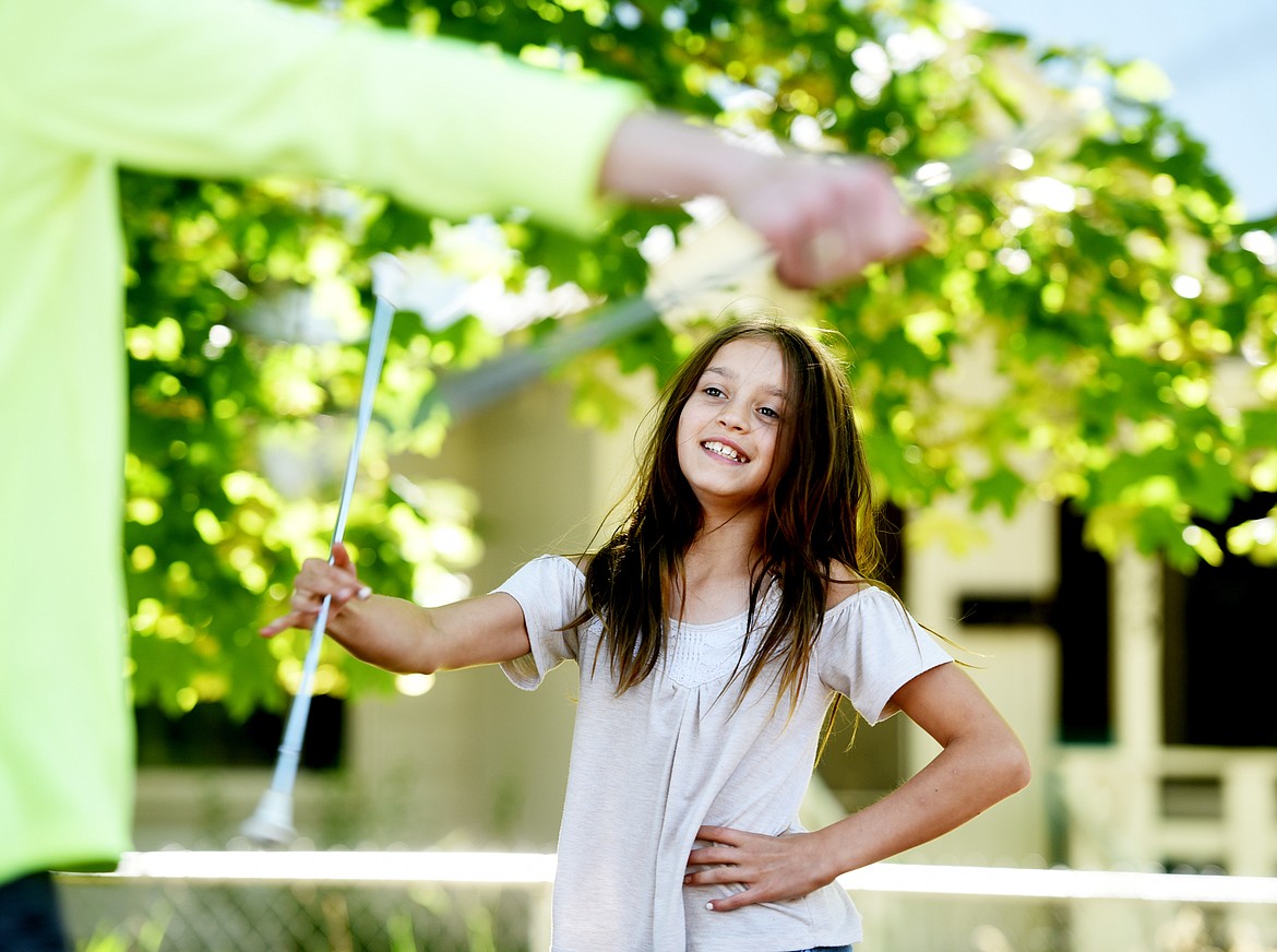 Dacia Benkelman and members of the Treasure State Twirlers practice outside Hedges Elementary on Tuesday morning, June 26. (Brenda Ahearn/Daily Inter Lake)