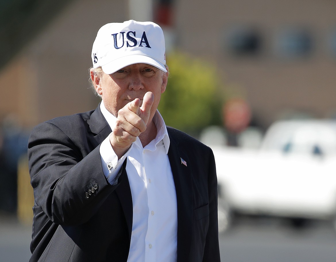President Donald Trump points before boarding Air Force One at Morristown Municipal Airport, in Morristown, N.J., Sunday, July 8, 2018, en route to Washington from Trump National Golf Club in Bedminster, N.J. (AP Photo/Carolyn Kaster)