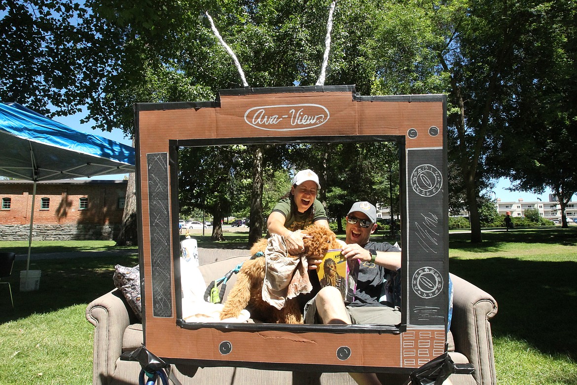 DEVIN WEEKS/Press
Stephen and Christie Boyd&#146;s poodle mix, 4-month-old Groot, helps himself to some kettle corn Saturday afternoon just before the Gizmotion parade in Coeur d&#146;Alene City Park. The Boyds rolled through the parade on a &#147;couchmobile,&#148; a human-powered vehicle that moves with bike pedals and a steering rudder on the back. The &#147;TV frame&#148; was added this year by the Boyds to add some flair to the entry, a favorite that has appeared in previous Gizmotion parades.