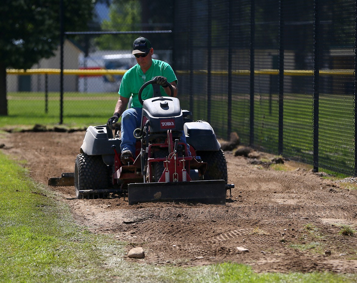 City of Post Falls employee Kirk Fisher creates a new baseball field warning track at Sports Mans Park on Wednesday, June 27, 2018 in Post Falls.  (LOREN BENOIT/Press)