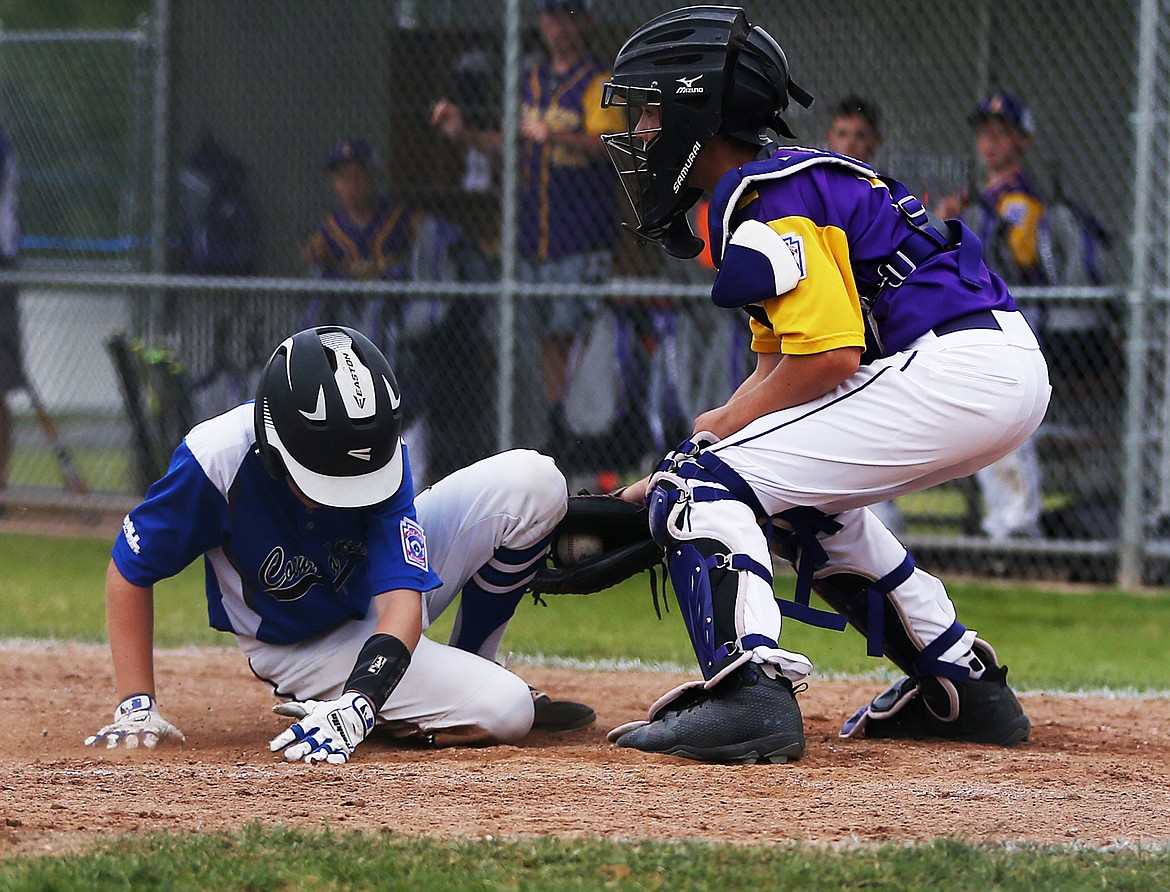 Coeur d&#146;Alene&#146;s Avery Cherry slides safely into home plate to score a run in a Little League Majors District 1 tournament game against Lewiston on Friday evening at Canfield Sports Complex. 

LOREN BENOIT/Press