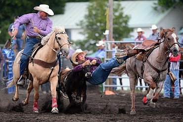 Kris Anderson, center, of Hamilton, competes during the Steer Wrestling event at the Bigfork Summer Pro Rodeo on Friday. (Casey Kreider/Daily Inter Lake)