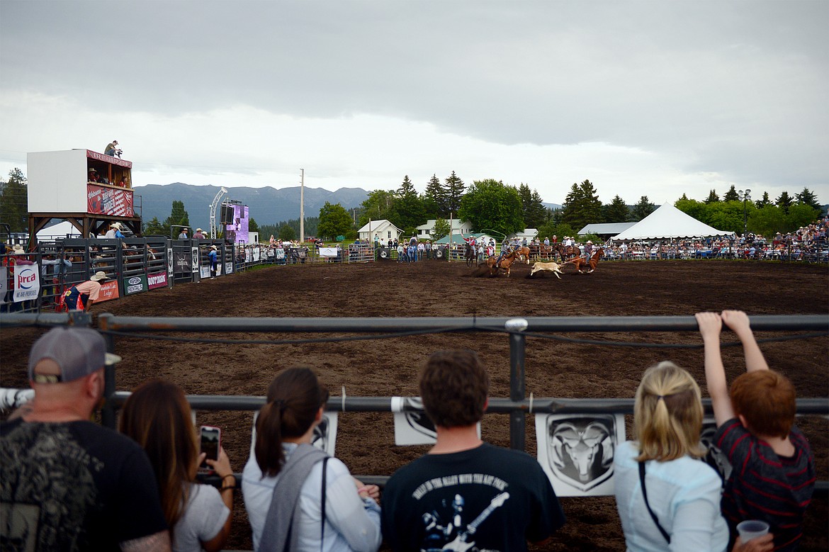 Spectators watch the Team Roping event at the Bigfork Summer Pro Rodeo on Friday. (Casey Kreider/Daily Inter Lake)