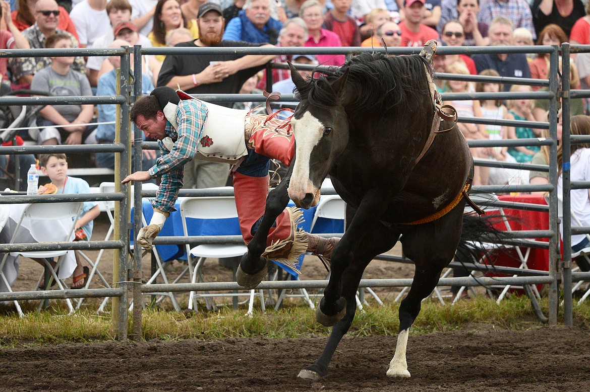 George R. Gillespie IV, of Darby, is thrown from his horse 3 Seconds Out during the Bareback Riding event at the Bigfork Summer Pro Rodeo on Friday. (Casey Kreider/Daily Inter Lake)