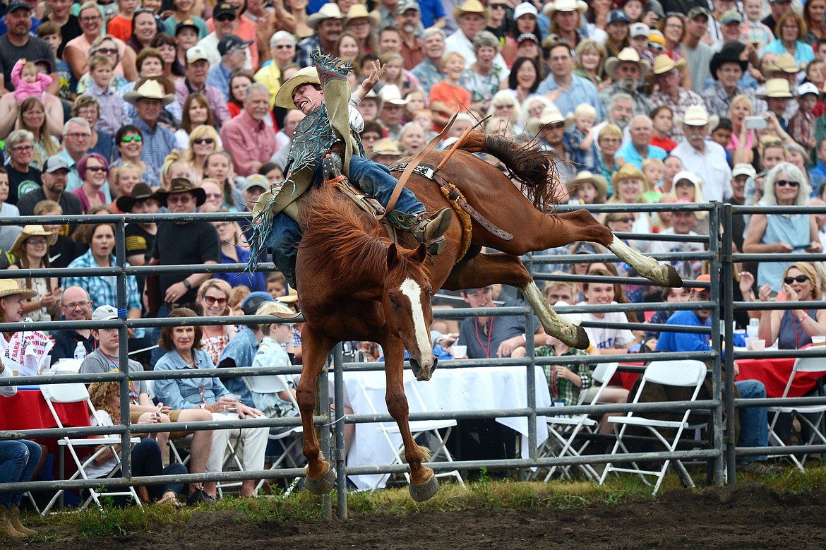 Troy Kirkpatrick, of Wise River, hangs on to his horse Sage Brush during the Bareback Riding event at the Bigfork Summer Pro Rodeo on Friday. (Casey Kreider/Daily Inter Lake)