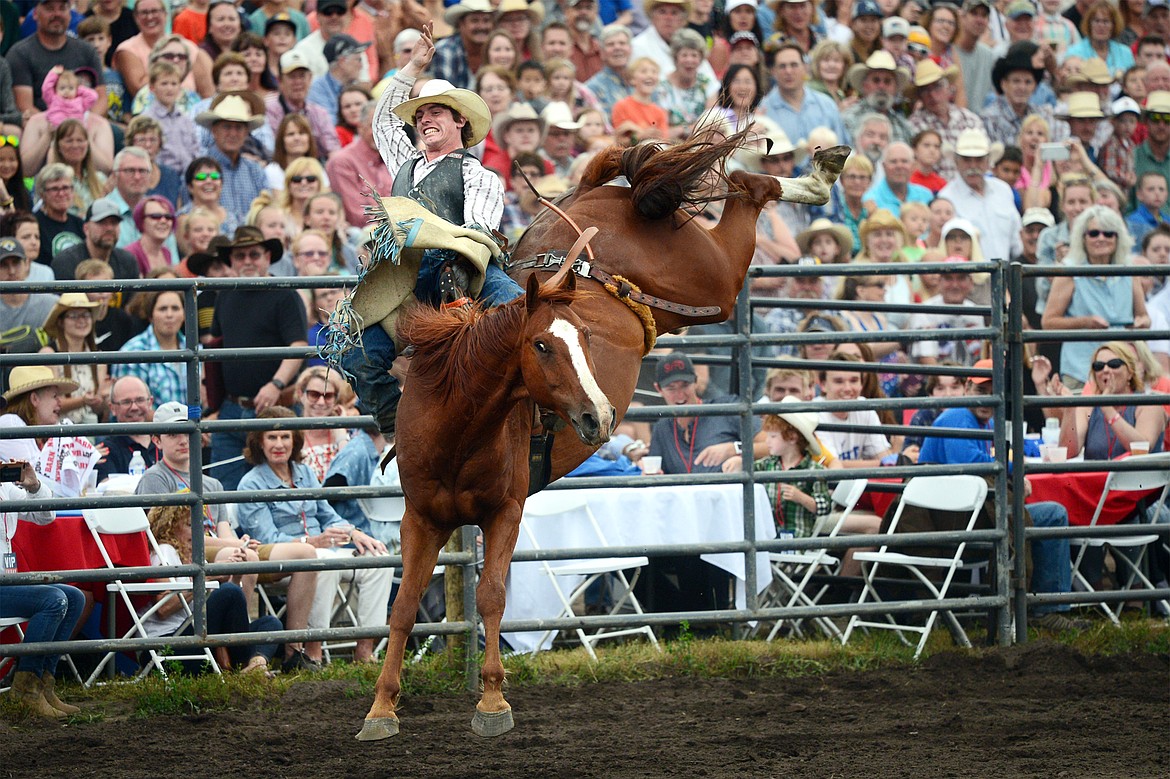 Troy Kirkpatrick, of Wise River, hangs on to his horse Sage Brush during the Bareback Riding event at the Bigfork Summer Pro Rodeo on Friday. (Casey Kreider/Daily Inter Lake)