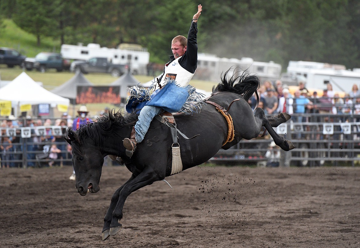 Pascal Isabelle, of Okotoks, Alberta, Canada, hangs on to his horse Midnight Dolly during the Bareback Riding event at the Bigfork Summer Pro Rodeo on Friday. (Casey Kreider/Daily Inter Lake)