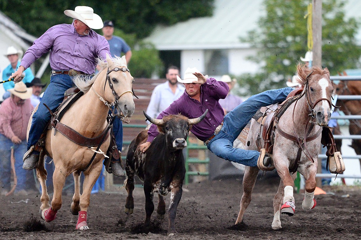 Kris Anderson, center, of Hamilton, competes during the Steer Wrestling event at the Bigfork Summer Pro Rodeo on Friday. (Casey Kreider/Daily Inter Lake)