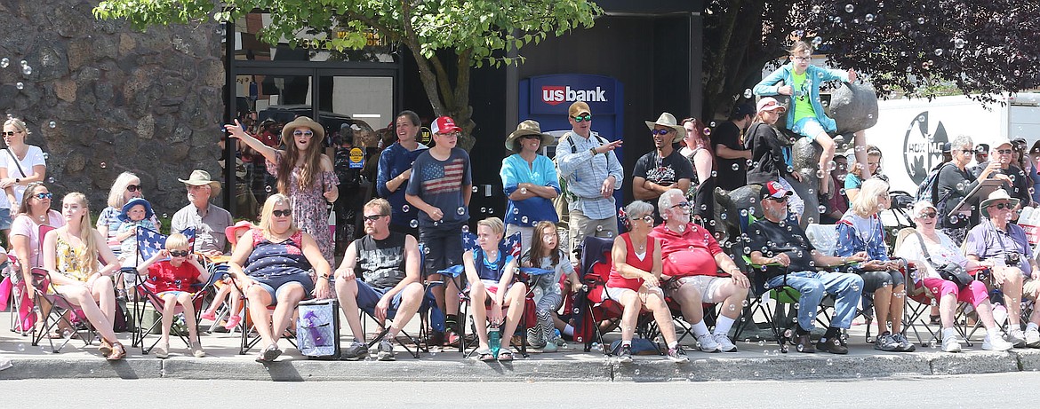 JUDD WILSON/Press
Parade watchers enjoy bubbles, camaraderie, and beautiful weather on the Fourth of July in Coeur d&#146;Alene.
