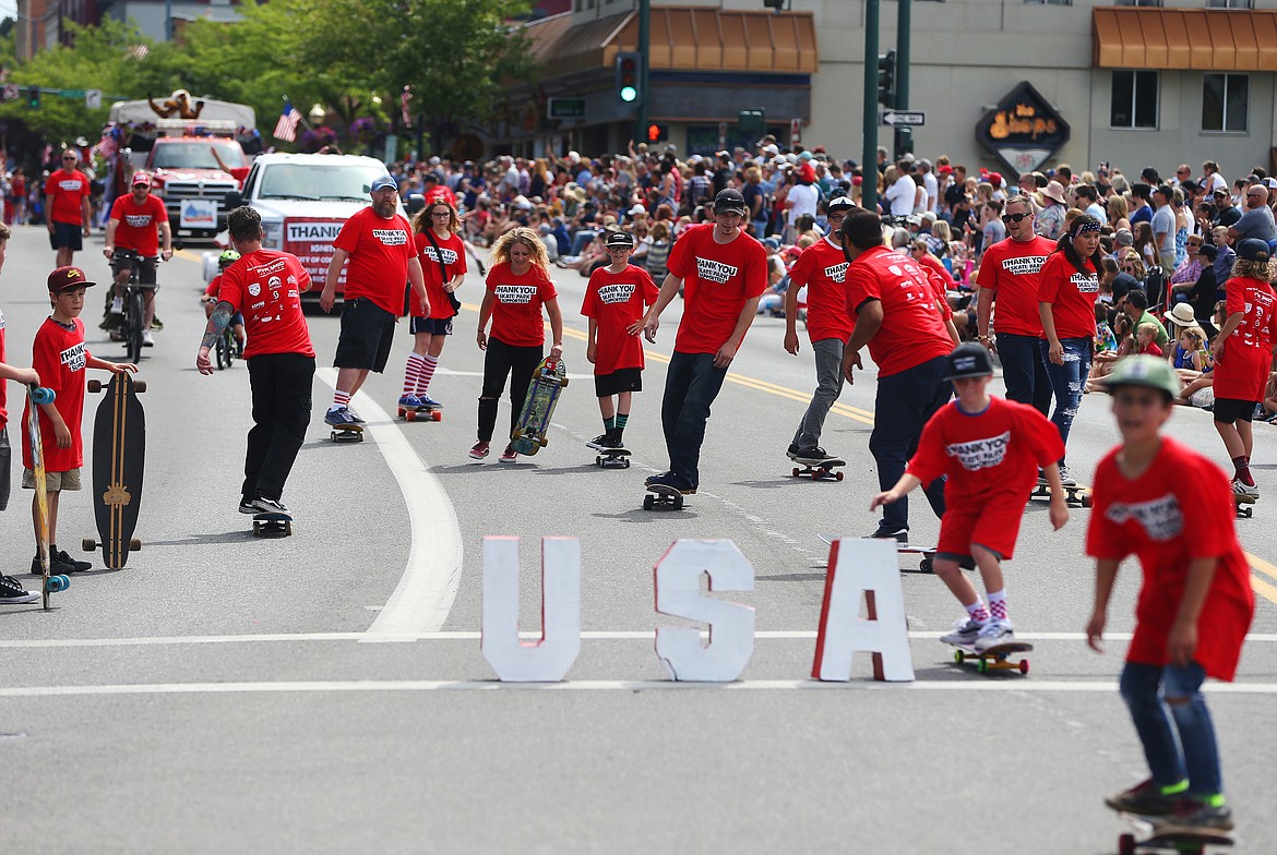 Skaters and supporters of the new Coeur d'Alene skate park ride down Sherman Avenue during the Fourth of July Parade. (LOREN BENOIT/Press)