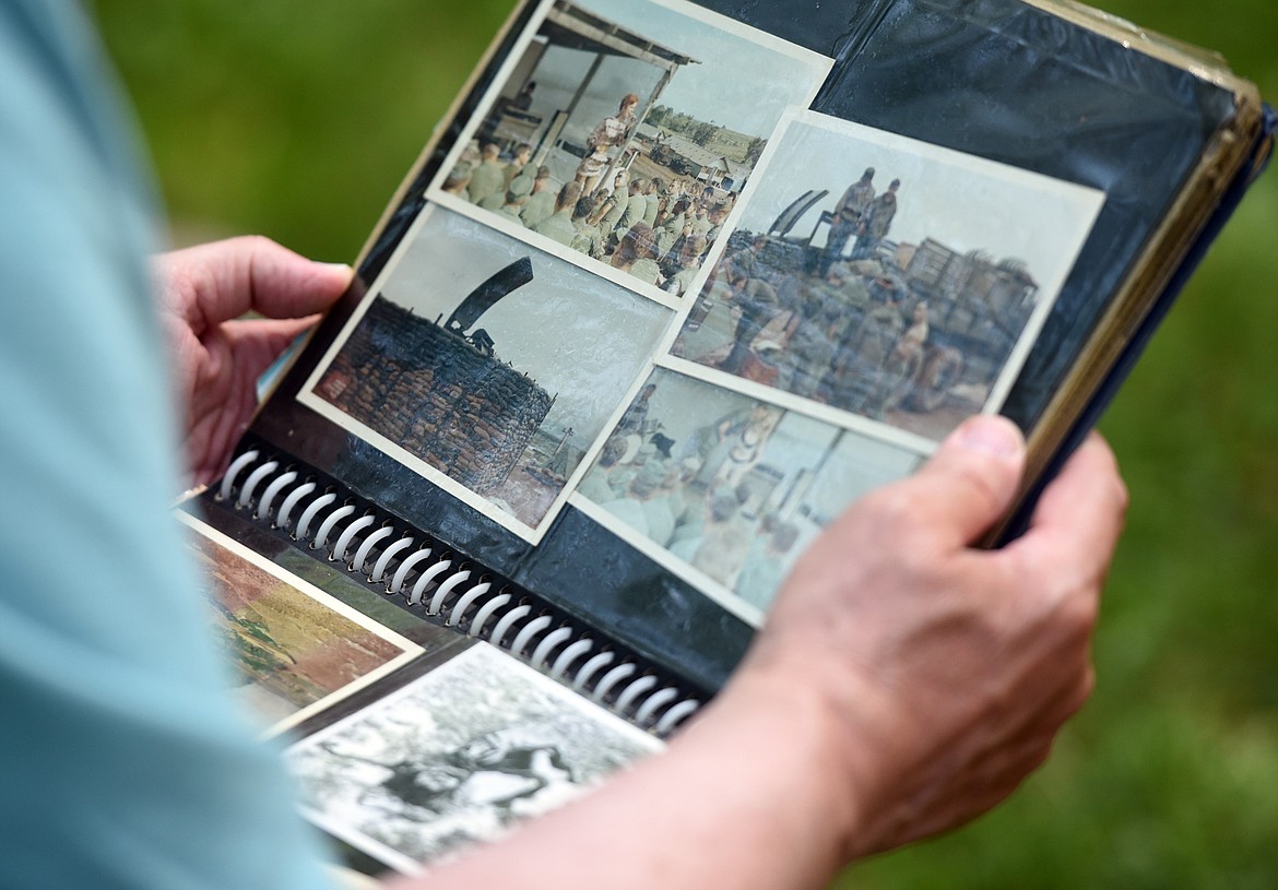 Tim Donovan of Queensbury, New York looks through one of the many photo albums the Marines brought with them to the reunion.